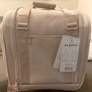 Calpak Murphie  15.5 under seat soft sided carry on suitcase.